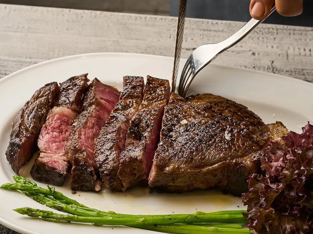 A sliced steak dish served with sauce at Bondi & Bourke.