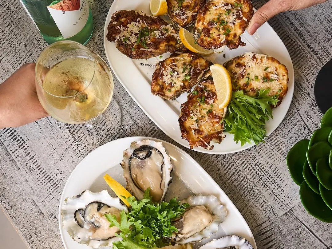Shared plates and oysters arranged on a Bondi & Bourke table.