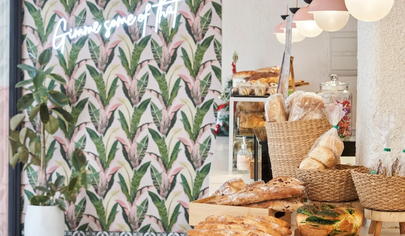 A bright Bramble Bakehouse counter with pastries and cafe seating.